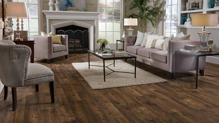 dark stained laminate flooring with rustic knotting and whirls in an elegant formal living room with a fireplace
